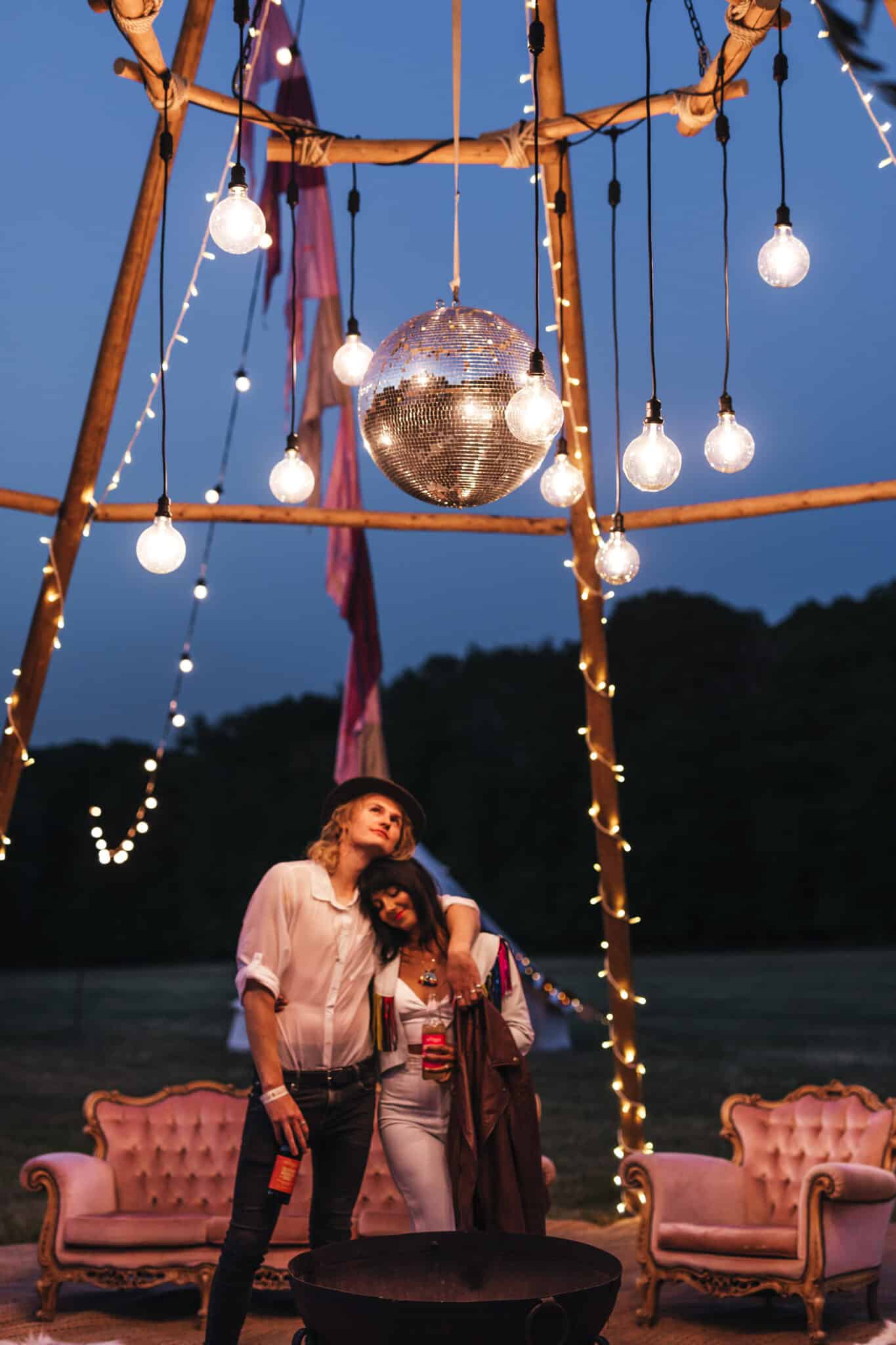 Naked tipi, blush sofa set, kadai fire bowl, fairy lights, mirror ball, halo, festival flag copy
